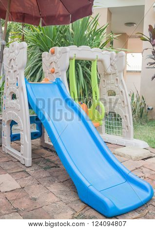 Home playground swing set in garden, stock photo