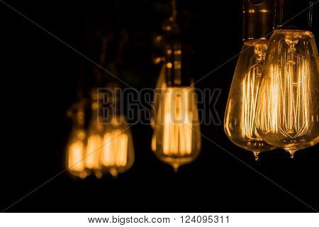 Vintage Edison Light Bulbs hanging against a black  background