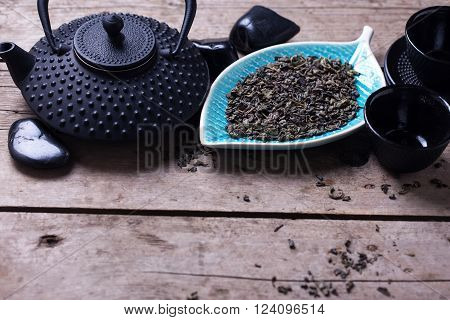 Traditional asian tea set on aged wooden background. Selective focus. Place for text.