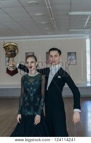 Professional dancers dancing in ballroom. Young couple