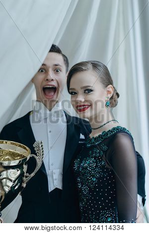 Professional dancers dancing in ballroom. Young couple