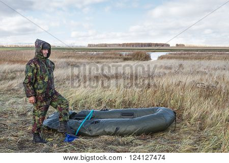 Hunter pumps up an inflatable boat .