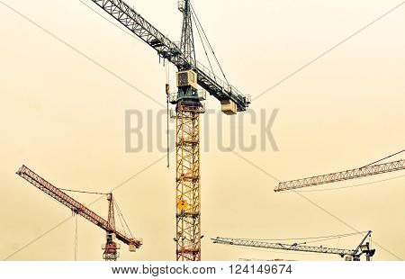 industrial background with construction cranes, Vvintage efffect
