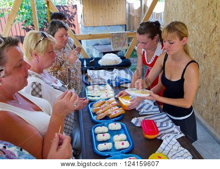 Lazarevskoe, Russia - august 08, 2012, Tourists tasting Adygei cheese on the product presentation, Lazarevskoe