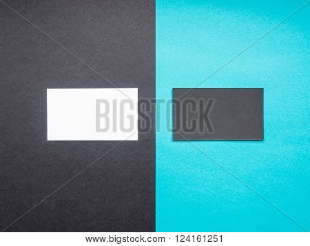 Two blank business cards on black and scuba blue color background