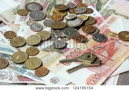The keys of Russian paper money and metal on wooden table top view. Rubles and kopecks.