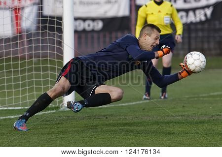 BUDAPEST HUNGARY - APRIL 2 2016: Goalkeeper Andras Horvath of Honved saves the ball during Budapest Honved - Videoton OTP Bank League football match at Bozsik Stadium.