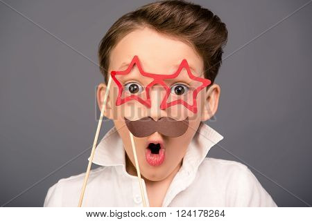 Close Up Portrait Of Surprised Funny Schoolboy Holding Props