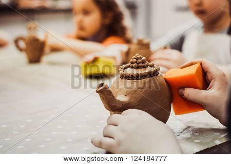 children's hands sculpts clay crafts pottery school