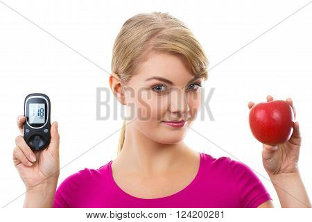 Happy woman holding glucose meter with positive result of measurement sugar level and fresh ripe apple concept of diabetes checking sugar level white background