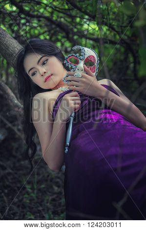 portrait of asia women with mask on nature canival concept