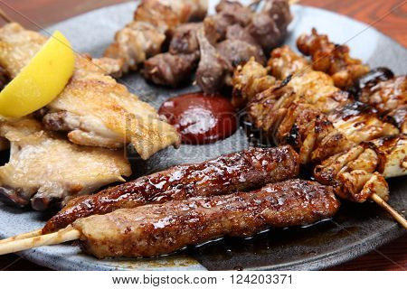 Japanese style chicken barbecue YAKITORI  on a dinibg table