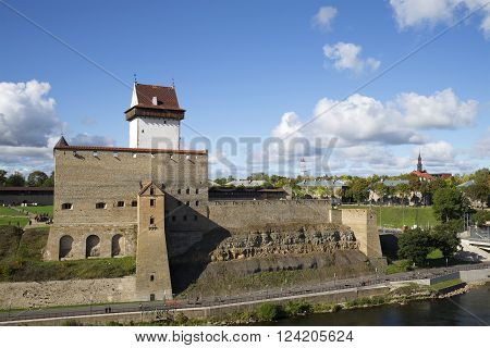 NARVA, ESTONIA - SEPTEMBER 27, 2015: Hermann castle on the background of the city of Narva october sunny day. The historic landmark of the city of Narva