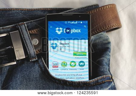 SARANSK, RUSSIA - APRIL 3, 2016: Photo of Smartphone in a jeans pocket with Dropbox application in a Google Play Store on the screen.