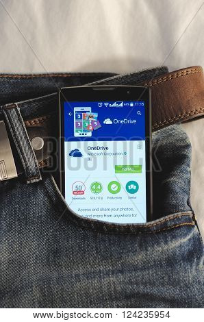 SARANSK, RUSSIA - April 3, 2016: Photo of Smartphone in a jeans pocket with OneDrive application in a Google Play Store on the screen.