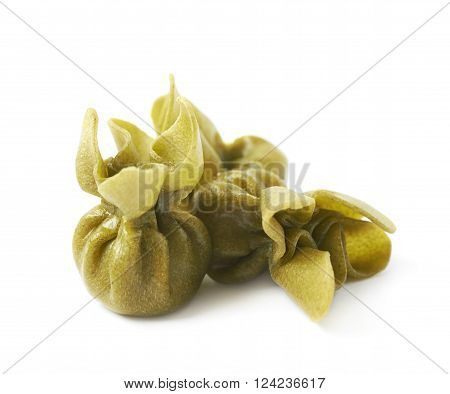 Pile of few sacchettoni stuffed pasta isolated over the white background