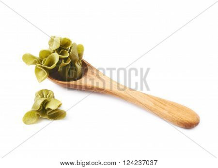 Wooden spoon full of sacchettoni stuffed pasta isolated over the white background