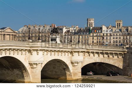 The pont Neuf is the oldest standing bridge across the river Seine in Paris.The bridge is composed of two separate spans one of five arches joining to the left bank to the Ile de la Cite another of seven joining the island to the right bank.