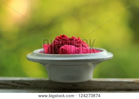 Red rose in a tea cap on the windowsill
** Note: Shallow depth of field