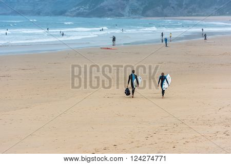 Surfers Walking Together Towards The Ocean