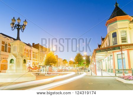 Wanganui, New Zealand - February 20, 2016: Wanganui, New Zealand - February 20, 2016: Night street scenes in city Wanganui historic and deco buildings around the light standard roundabout and light streaks of cars driving along Victoria Avenue through dow