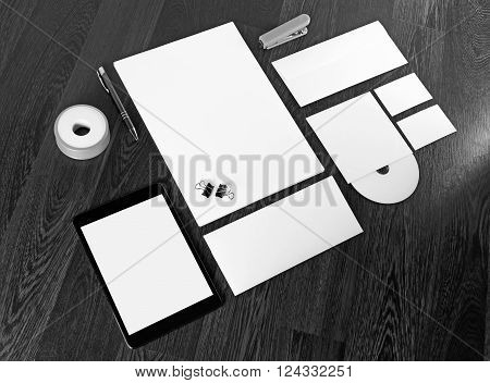 Photo of blank stationery and corporate identity template on dark wooden background. Blank template for design presentations and portfolios.