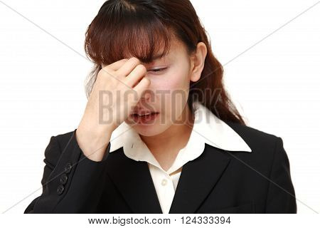 portrait of Asian businesswoman suffers from Asthenopia