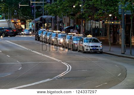Sydney Australia - November 10 2015: Taxi queued for passengers in Sydney CBD at night. The state of New South Wales is served by a fleet of around 6000 taxis. The industry employs over 22700 taxi drivers.