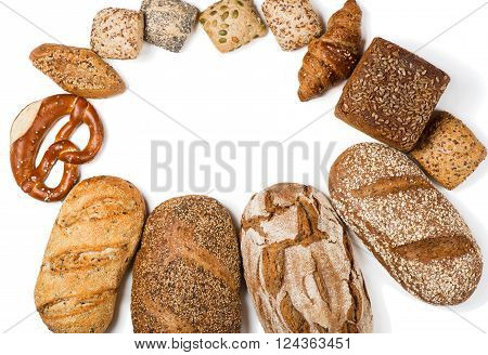 Top view of assortment of different kind of cereal bakery: bread pasties buns pretzel and croissant isolated on a white background with space.