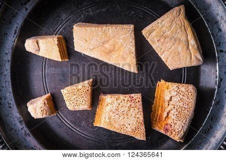 Pieces of pastila on the metal plate top view