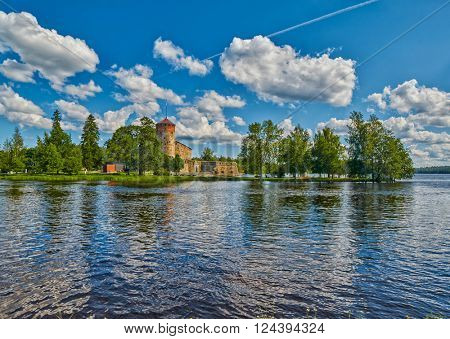 Lake view with reflections of Olavinlinna Olofsborg, the 15th-century medieval three-tower castle located in Savonlinna, Finland.