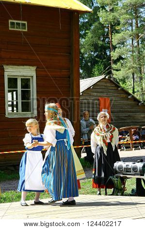 HELSINKI FINLAND - JUNE 20 2012: Unidentified dancers in folklore ensemble in traditional folk costumes at midsummer day festival.