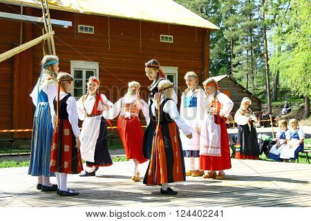 HELSINKI FINLAND - JUNE 20 2012: Unidentified dancers in folklore ensemble in traditional folk costumes at midsummer day festival