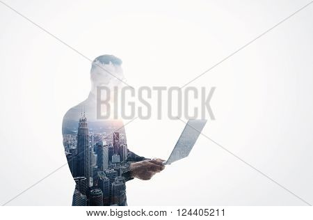 Double exposure young bearded businessman wearing black shirt and glasses. Banker holding contemporary notebook hands. Working online banking. Isolated white, modern skyscraper city background.