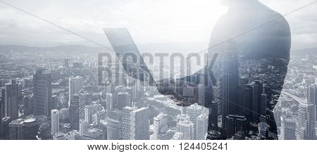 Double exposure businessman wearing black shirt, panoramic view. Banker holding contemporary notebook hands.Work online banking. Isolated white, modern skyscraper city background.