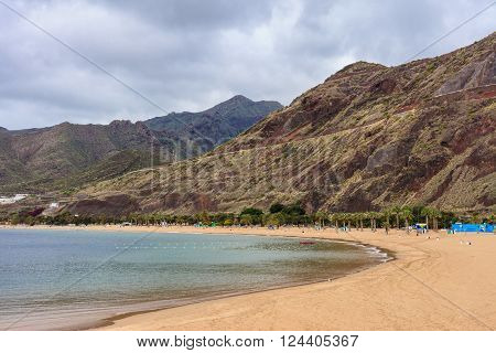 Summer seascape on tropical island Tenerife, Canary in Spain. Playa de Las Teresitas beach with gold sand brought from Sahara desert view on capital city Santa Cruz De Tenerife.