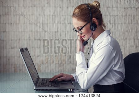 Female customer support emloyee talking online in office