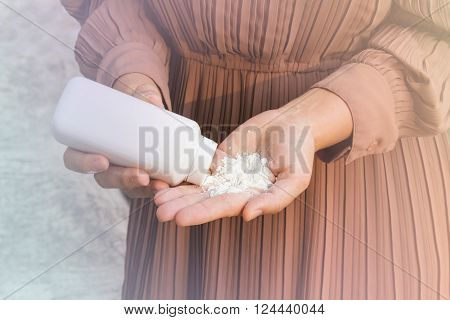 Close up women hands apply talcum powder