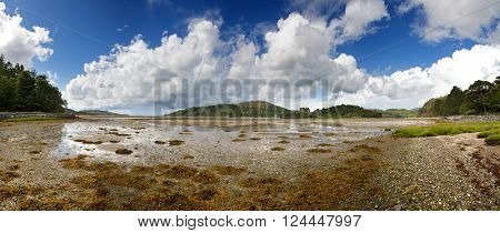 A panoramic view across to the ruins of Castle Tioram, which stands on the tidal island of Eilean Tioram in Loch Moidart, Highlands, Scotland. 