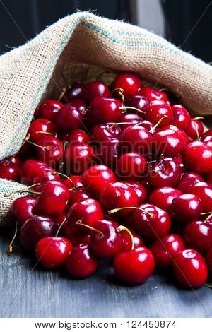 a group of fresh red cherry on wood