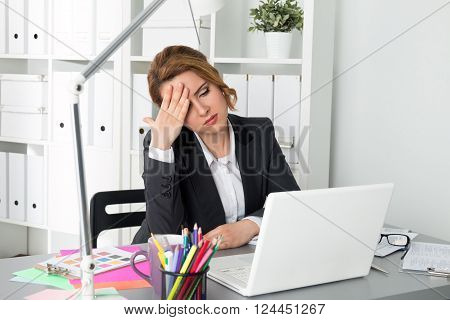 Portrait Of Tired Businesswoman Sitting At Her Office