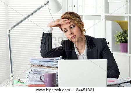 Portrait Of Tired Businesswoman Sitting At Her Office