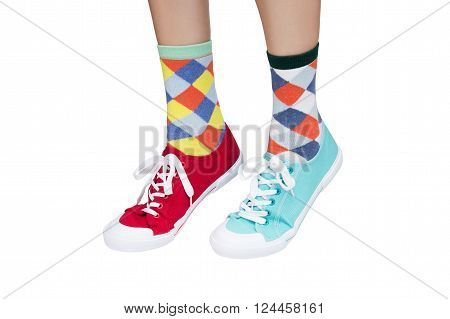 wearing funny socks and different sneakers on legs