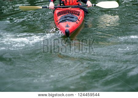 red kayak in rough water front view boat detail of prow and paddle concept for leisure and water sports generous copy space