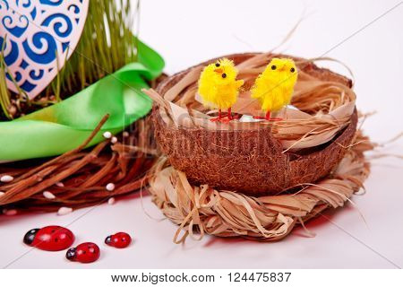 Decorative yellow chickens in a basket. Feast of Easter