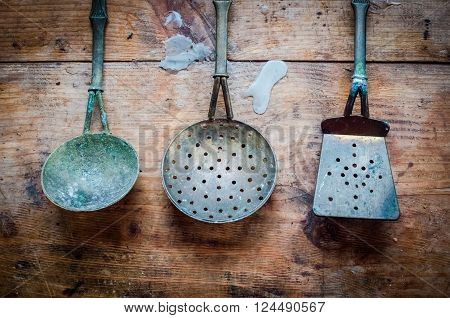 Vintage kitchen utensils on rustic wood background. Vintage utensils on scratched grunge wood surface. Horizontal. Top view.
