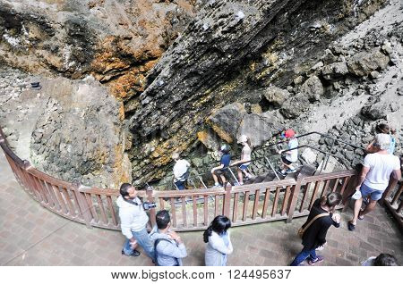 MARGARET RIVER,WA,AUSTRALIA-JANUARY 17,2016: Tourists heading down the steep steps to the doline entrance to the Lake Cave tourist attraction in Margaret River, Western Australia.