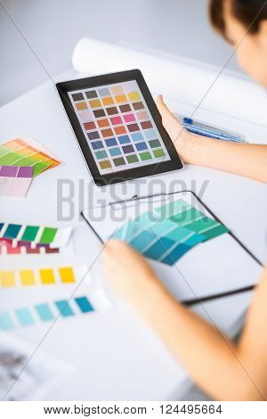 interior design, renovation and technology concept - woman working with color samples for selection