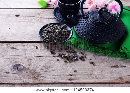 Green tea in bowl and traditional asian tea set on aged wooden background. Selective focus is on tea. Place for text.
** Note: Visible grain at 100%, best at smaller sizes