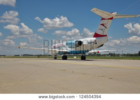 Borispol Ukraine - July 5 2014: Austrian Airlines Fokker-70 passenger plane taxiing to the terminal after landing - rear view